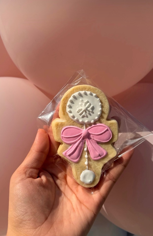 Nutcracker Christmas cookie with pink bow - elegant holiday cookie design